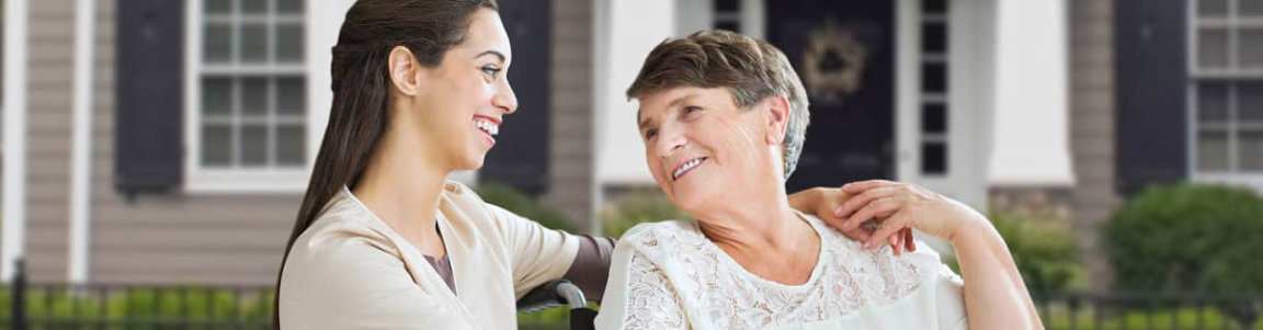 senior woman and woman facing each other