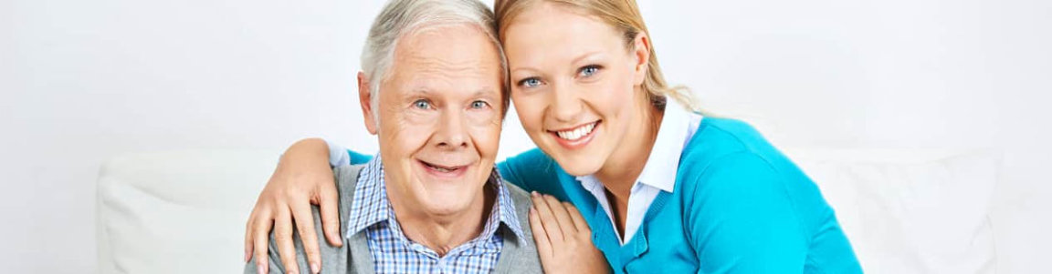 senior man smiling with caregiver