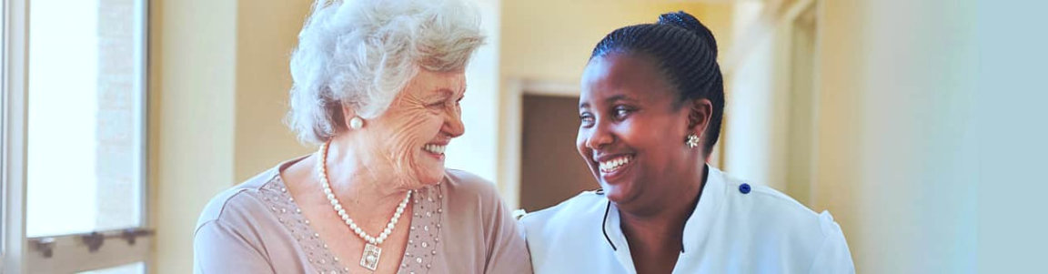 senior woman smiling with female caregiver